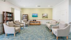 Bupa Aged Care Mount Sheridan lounge with books and Feb 2021